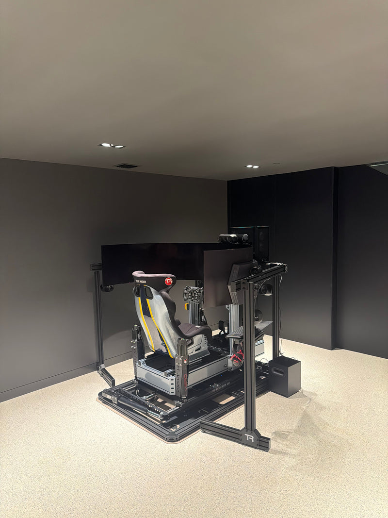 High-end custom racing simulator installed by Premier Sim Racing with triple monitors, direct-drive wheelbase, performance pedals, and racing cockpit.